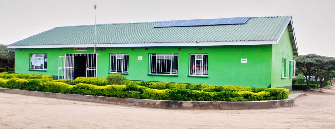 Classroom block with solar panels and trimmed hedges