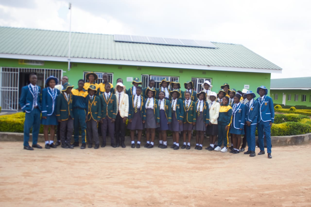 Whole-school group in front of a classroom block